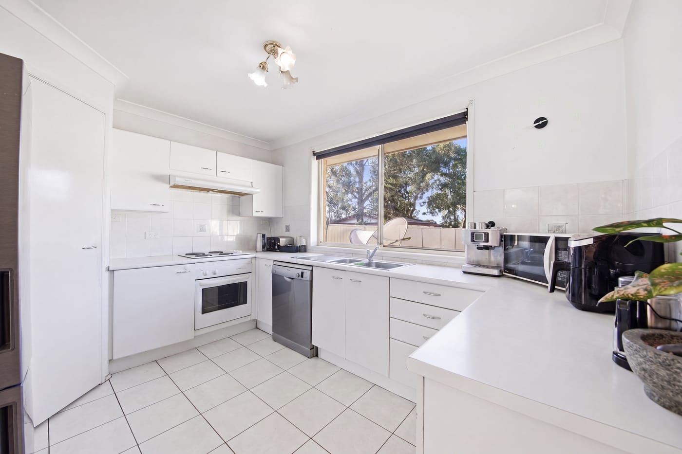 Digital Tidy-Up premium edit — the same kitchen decluttered, before shown inset